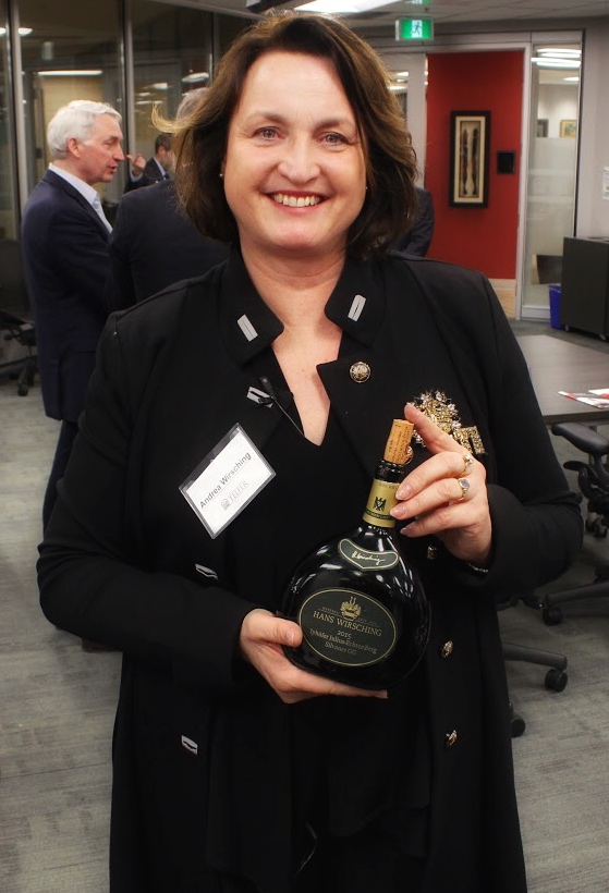 Andrea Wirsching at the University of Ottawa with a bottle of Hans Wirsching wine